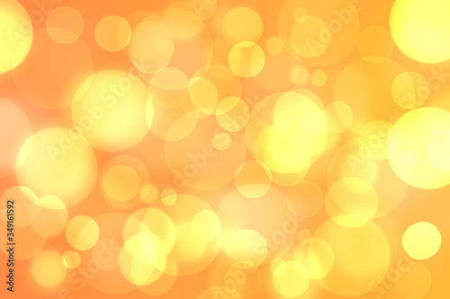 A festive abstract delicate golden yellow gradient background texture with glitter defocused sparkle bokeh circles. Card concept for Happy New Year, party invitation, valentine or other holidays.