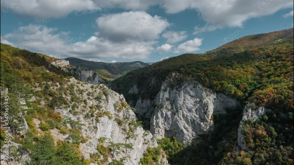Clouds slowly swim among the mountainous scenic peaks, leaving under itself shadows. 4K Timelaps. Colorful backdrop. Hiking trail. Clouds slowly swim among the mountainous scenic peaks, leaving under itself shadows. 4K Timelaps. Colorful backdrop. Hiking trail.