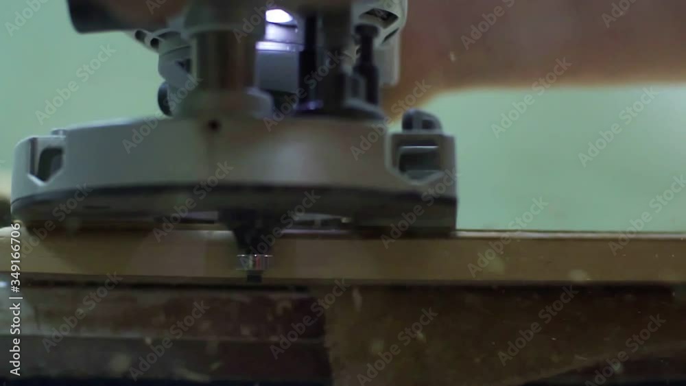 chamfer the door of the wood with a milling machine, a lot of chips in slow motion chamfer the door of the wood with a milling machine, a lot of chips in slow motion