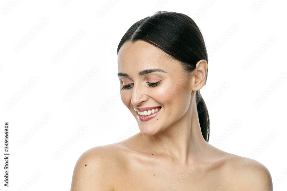 Beautiful smiling woman with clean skin, natural make-up, and white teeth on white background Beautiful smiling woman with clean skin, natural make-up, and white teeth on white background