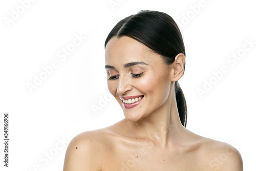 Beautiful smiling woman with clean skin  natural make-up  and white teeth on white background