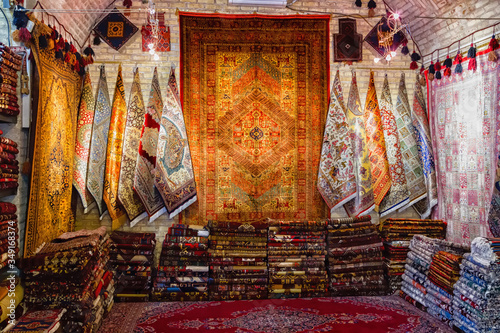 Traditional iranian carpets, rugs and scarfs shop in Isfahan bazaar. Esfahan bazaar is one of the oldest and biggest in Iran. photo