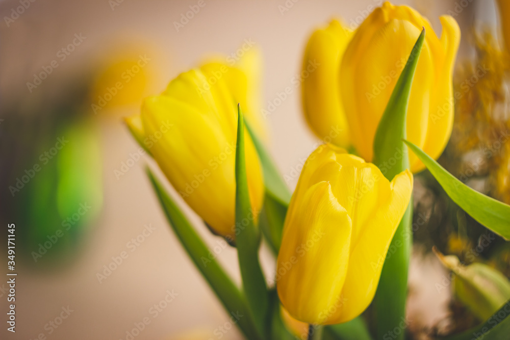 A bouquet of yellow flowers on a craft background; spring flowers on a blurred background