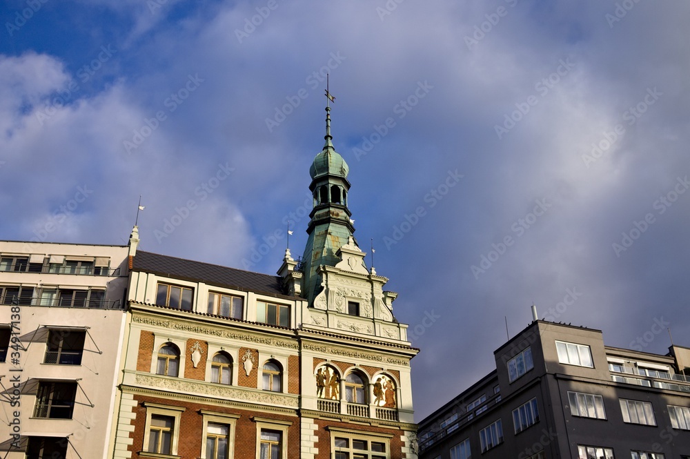 Obraz premium Old bohemian building with spire on the tower and beautiful decorations (Prague, Czech Republic, Europe)