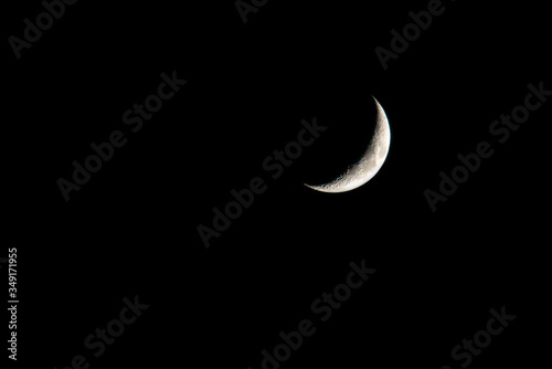 young moon on black background - Waxing Crescent