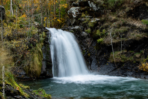Waterfall of the lighthouse river on its way through the town of Redipuertas in Leon