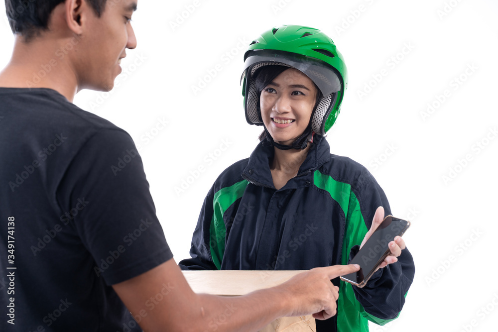 man signing to package he received from delivery courier man signing to package he received from delivery courier