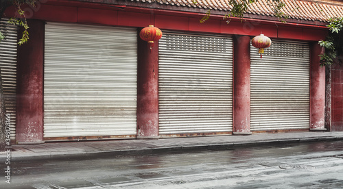 Photography Empty street and closed shops with red columns and lanterns, color toning applied, China