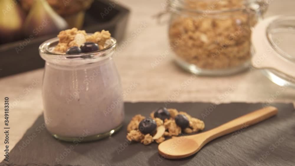 Yogurt with granola and blueberry on top - static Yogurt with granola and blueberry on top - static