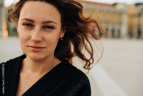 Foto Close up portrait of a millennial caucasian woman with freckles wearing black, looking at camera with contempt or hope face expression or emotion