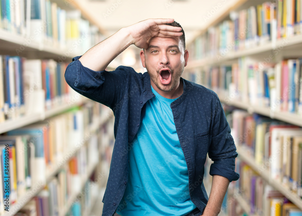 Young man wearing a blue outfit. Looking surprised.