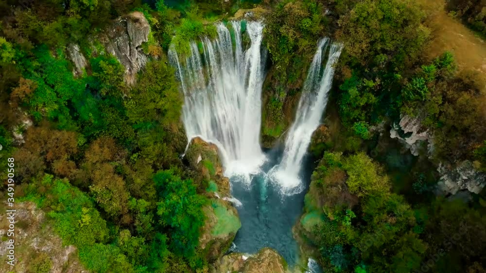 Waterfall from above in hidden forest of Croatia surrounded by green trees and fall foliage Waterfall from above in hidden forest of Croatia surrounded by green trees and fall foliage