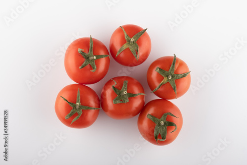 Ripe Fresh Cherry Tomatoes on Branch Isolated on White Background