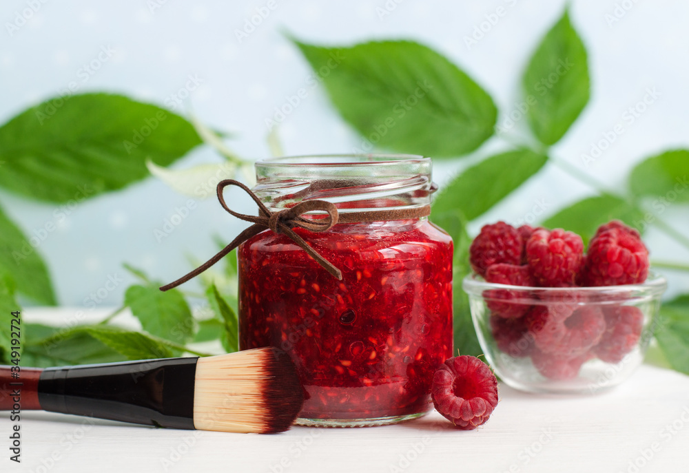 Homemade raspberry facial mask (exfoliating face and body sugar scrub) in the glass jar. Fruit DIY beauty treatment and spa recipe. Copy space Homemade raspberry facial mask (exfoliating face and body sugar scrub) in the glass jar. Fruit DIY beauty treatment and spa recipe. Copy space