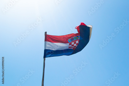 Croatian flag on a blue sky in summer photo