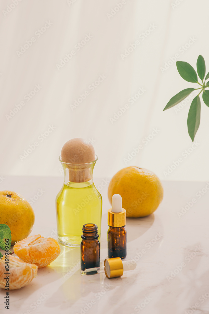Tangerine oil on table on light background Tangerine oil on table on light background