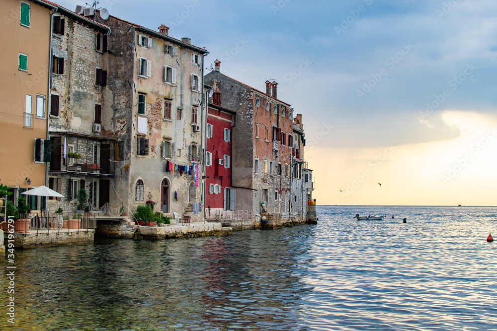 View of the typical croatian old houses in the coastline of the old town of Rovinj, Croatia, just on the Adriatic Sea, during the sunset