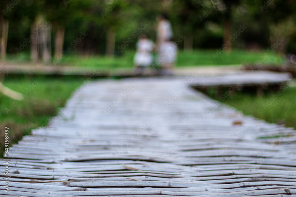 A wooden bridge in the park with a blurred background A wooden bridge in the park with a blurred background
