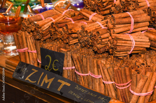 Bunch of cinnamon sticks for sale on counter top at the Christmas market.