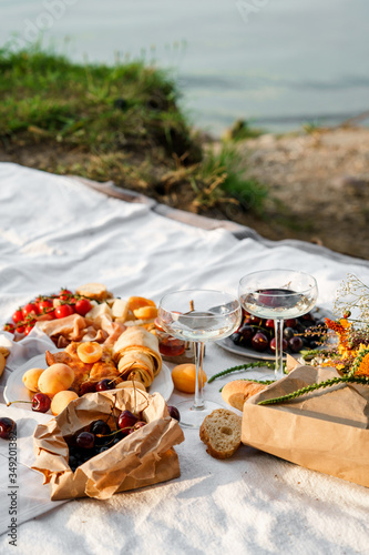 Romantic picnic with wine and snacks outdoors