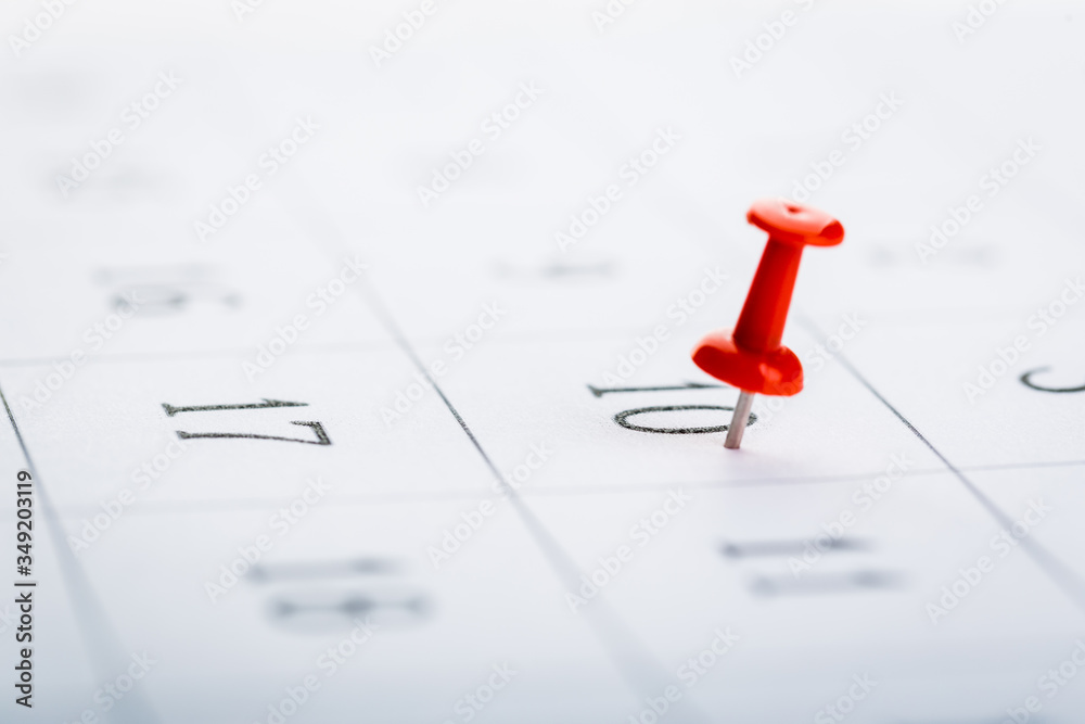 2020 calendar page marked with an important date in red pin. timeline, time, concept, idea, management 2020 calendar page marked with an important date in red pin. timeline, time, concept, idea, management
