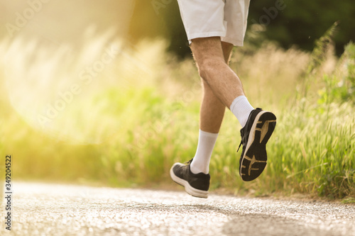 Detail of man running free in nature. Ideal to express the concept of vitality and healthy life. Copy space.