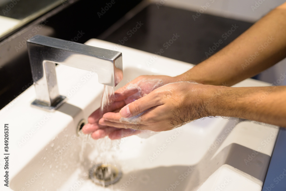 Hands of young man being washed and cleaned properly to prevent the spread of covid-19