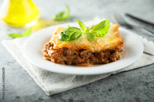 Traditional homemade lasagna served with fresh basil