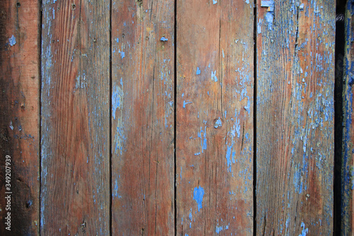 background of dark brown planks and remnants of blue paint