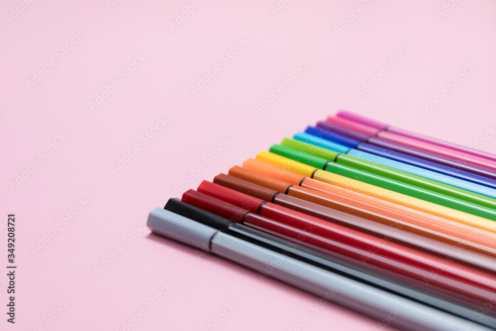 .Colored felt-tip pens on a pink background. A set of markers for drawing, creativity, hobbies, classes. Angle view, close-up, macro .Colored felt-tip pens on a pink background. A set of markers for drawing, creativity, hobbies, classes. Angle view, close-up, macro