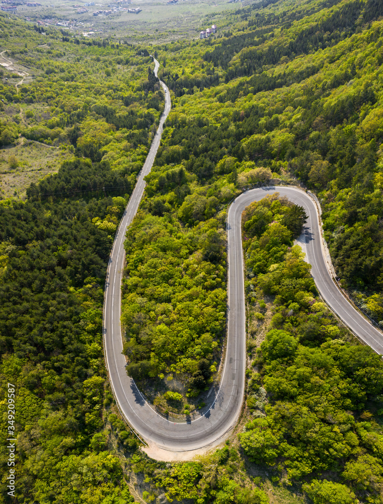 Aerial view of drone to road through mountain with bends