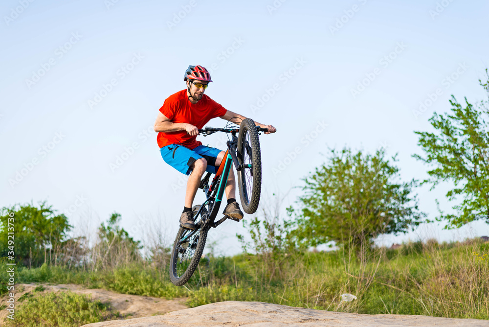Extreme cycling concept, cyclist jumping on a mountain bike. Extreme cycling concept, cyclist jumping on a mountain bike.