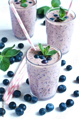Blueberry smoothie in glass with mint leaves