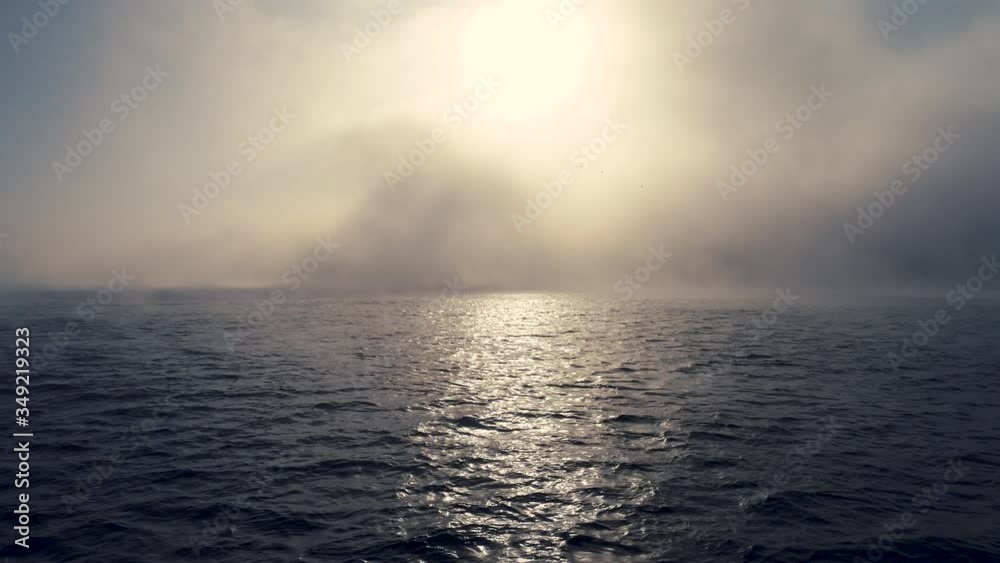 Foggy morning over the ocean waves. Sunrise and ripple water view Foggy morning over the ocean waves. Sunrise and ripple water view