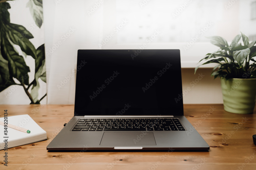 An open laptop to an old wooden table. An open laptop to an old wooden table.