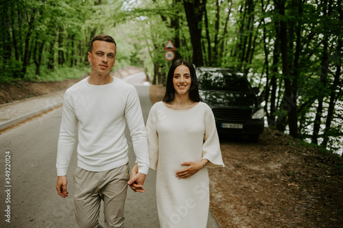 Beautiful pregnant couple in woods