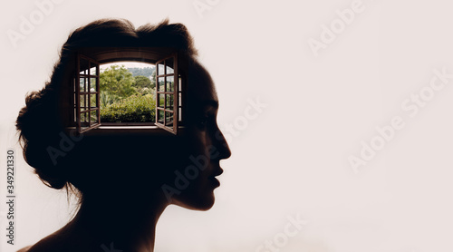 Beautiful woman with opened window with garden in her head. photo