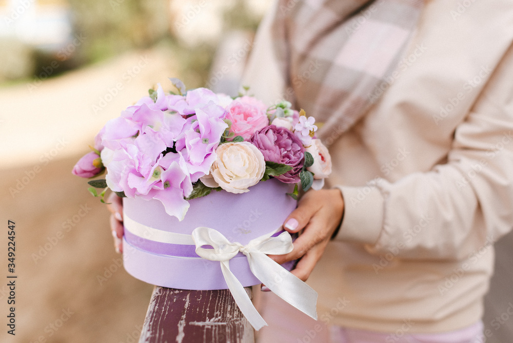 Artificial flowers. Decorative flowers in a round box. Flowers in purple. Artificial flowers. Decorative flowers in a round box. Flowers in purple.