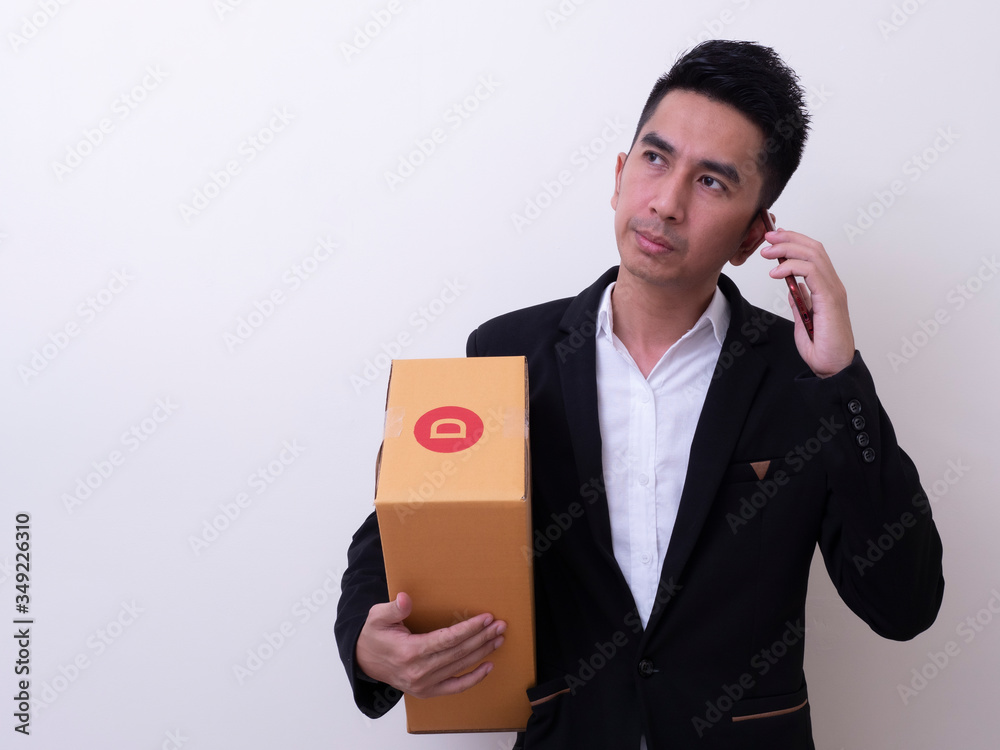 Shipper young Asian man holding cardboard box Shipper young Asian man holding cardboard box