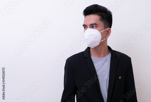 Asian young man and medical mask to protect COVID-19
