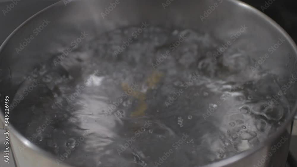 Pasta falls into the boiling water. Pasta falls into the boiling water.