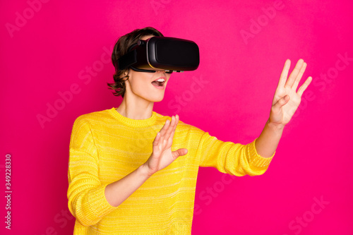 Portrait of positive cheerful youth teen girl have vr-box play virtual reality game search cyberspace wear style stylish trendy yellow jumper isolated over bright shine color background