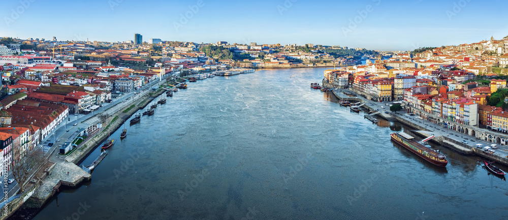 View of the city of Porto from the Eiffel Bridge early in the morning at dawn, small multicolored houses of the Ribeira Quarter