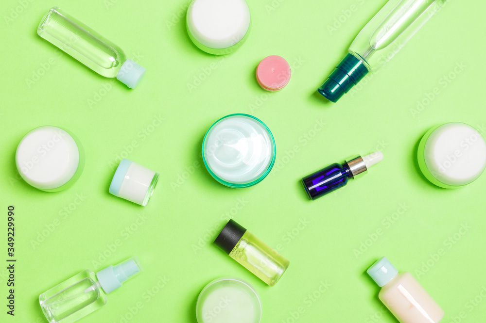 Group of plastic bodycare bottle Flat lay composition with cosmetic products on green background empty space for you design. Set of White Cosmetic containers, top view with copy space