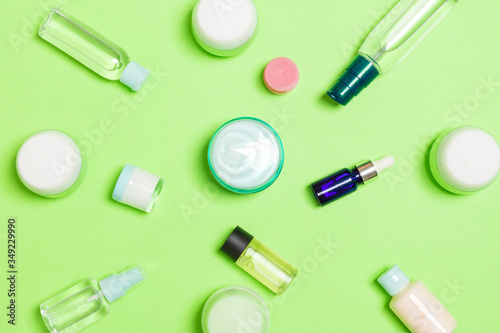 Group of plastic bodycare bottle Flat lay composition with cosmetic products on green background empty space for you design. Set of White Cosmetic containers, top view with copy space