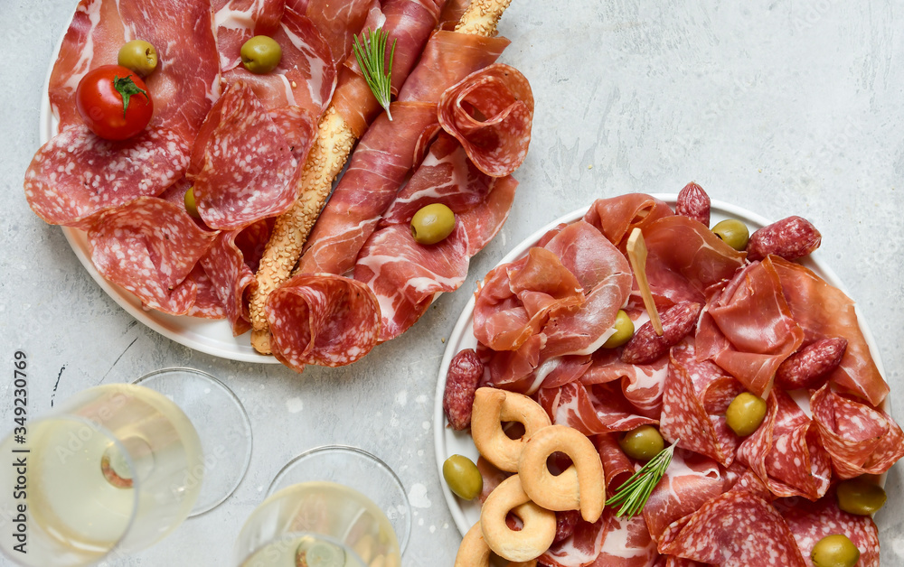 italian  prosciutto, salami, bresaola olives tomatoes and grissini bread sticks. Aperitif in Italy in Florence, Rome, aperitif in Milan. Serving appetizers for an aperitif, lunch, dinner and holiday.