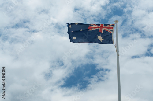 Australian flags against cloudy sky