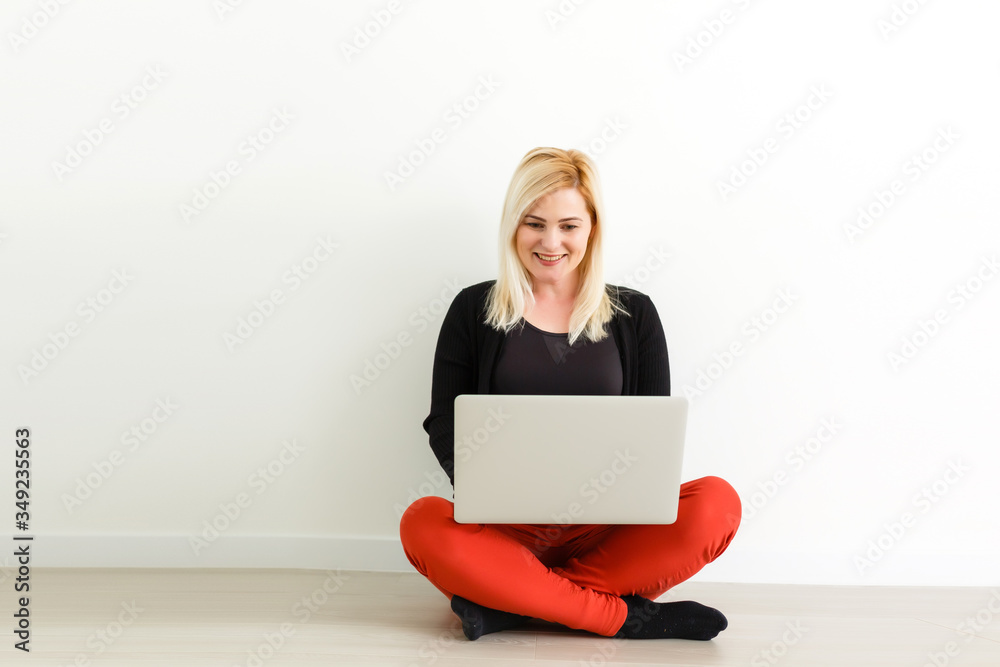 Woman working on a laptop isolated over a white background Woman working on a laptop isolated over a white background