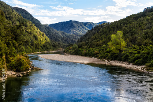 Beautiful blue green river flowing on summer time in New Zealand South Island photo