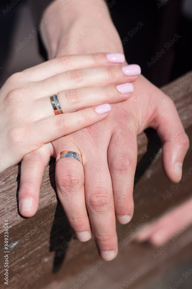 Hands of the newlyweds with wedding rings. Close-up. Hands of the newlyweds with wedding rings. Close-up.